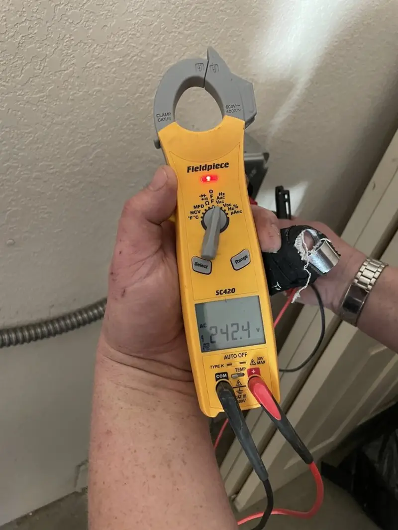 Voltage testing with clamp meter during Recessed Lighting Installation in South Annville